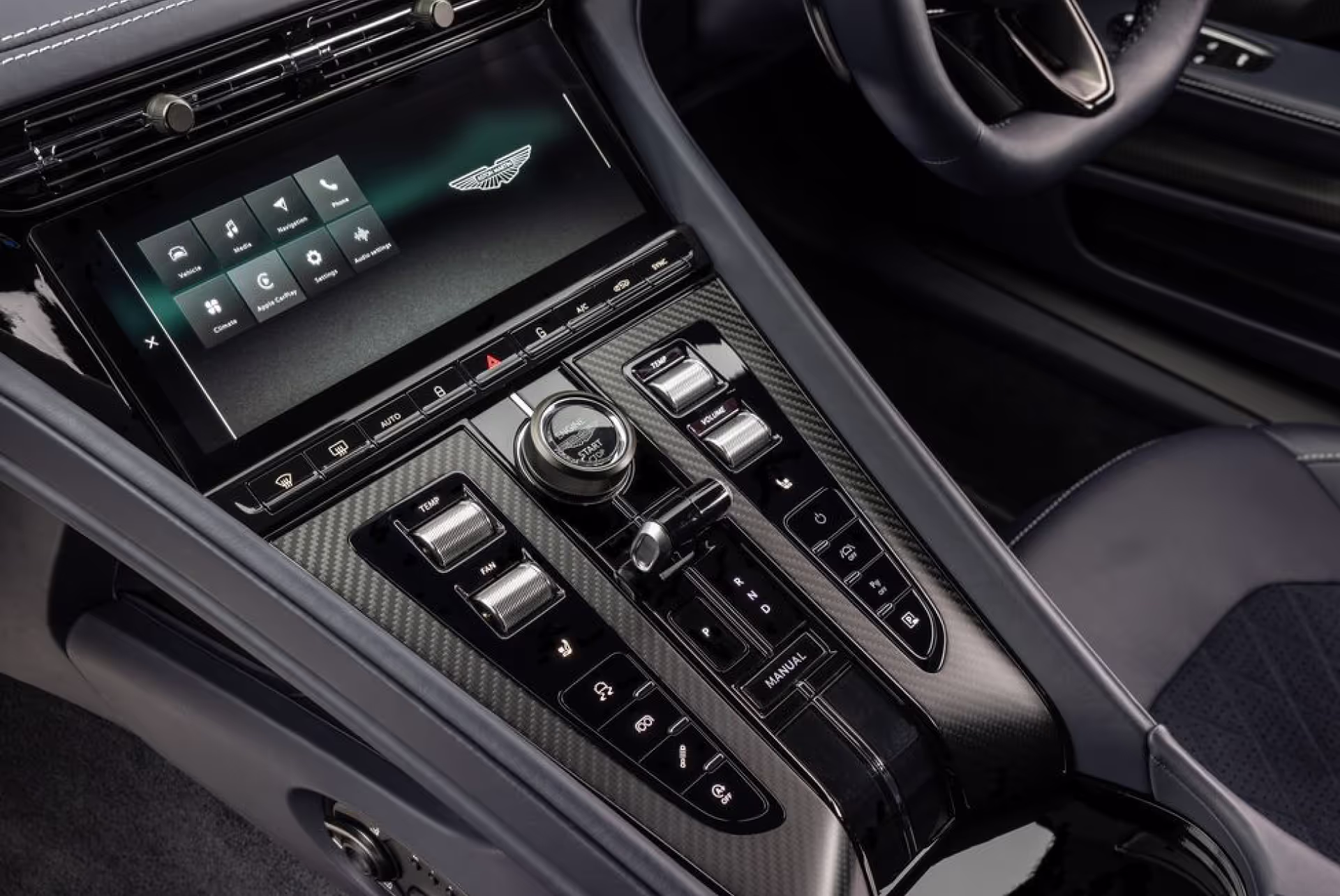 Close-up of an Aston Martin Lagonda's center console, showing its touchscreen infotainment display and control dial